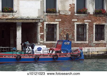Blue and red barge docked alongside red brick building in canal View Large Photo Image Stock Image - Blue and red barge docked alongside red brick building in canal. Fotosearch