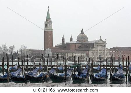Gondolas moored at canal side Canal di San Marco with San Giorgio Maggiore in the background View Large Photo Image Stock Photography - Gondolas moored at canal side Canal di San Marco with San Giorgio Maggiore in the background. Fotosearch