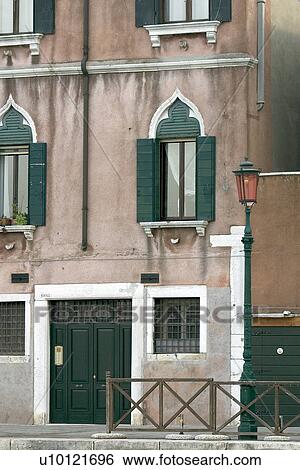 Stock Photograph - green doorway and shuttered windows. Fotosearch