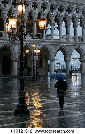 Man walking in rain with umbrella View Large Photo Image Stock Image - Man walking in rain with umbrella. Fotosearch