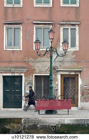 Stock Photo - person walking along edge of canal. Fotosearch