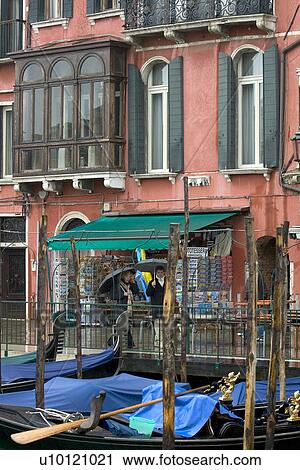 Stock Image - two people with umbrella walking alongside Grand Canal. Fotosearch