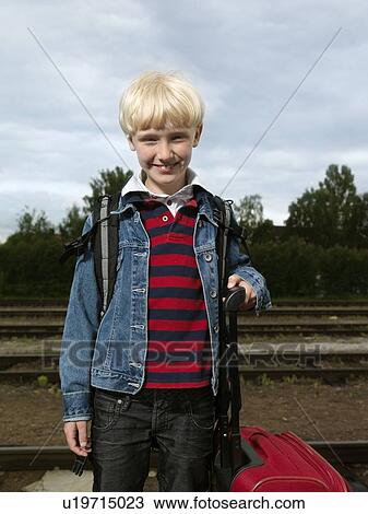 Stock Image - Boy on train station. Fotosearch