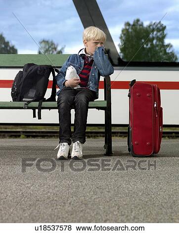 Stock Photo - Boy waiting on train station. Fotosearch