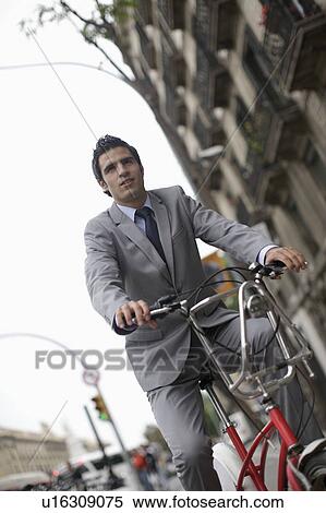 Stock Photography - Business man on bicycle. Fotosearch