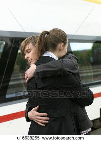 Couple embracing on train station View Large Photo Image Stock Photography - Couple embracing on train station. Fotosearch