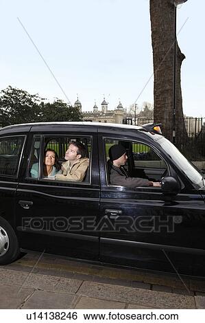 Couple looking out of London taxi window View Large Photo Image Stock Photograph - Couple looking out of London taxi window. Fotosearch