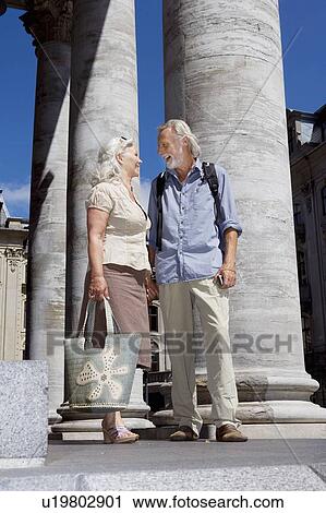 Stock Image - Couple standing talking. Fotosearch