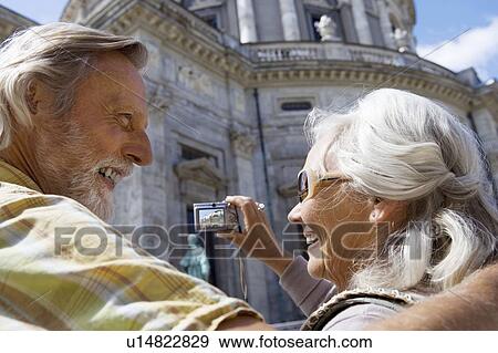 Couple taking picture of church View Large Photo Image Stock Photo - Couple taking picture of church. Fotosearch