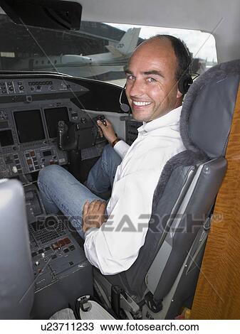 Male pilot in cockpit of private jet. View Large Photo Image Stock Image - Male pilot in cockpit of private jet.. Fotosearch