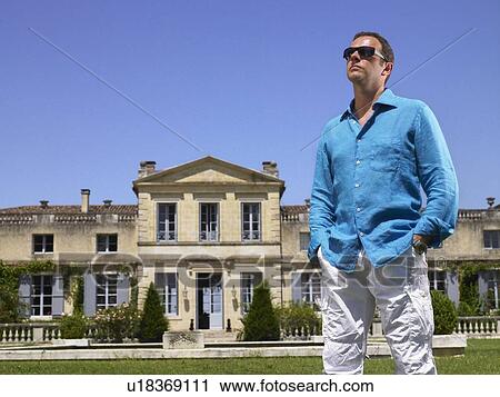 Stock Image - Man in front of a castle. Fotosearch