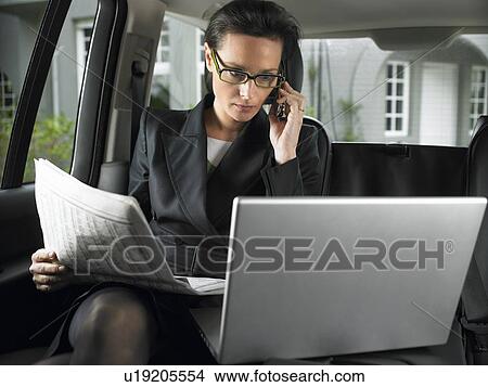 Woman in car, working View Large Photo Image Picture - Woman in car, working. Fotosearch