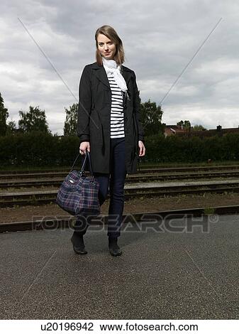 Woman on train station View Large Photo Image Stock Image - Woman on train station. Fotosearch