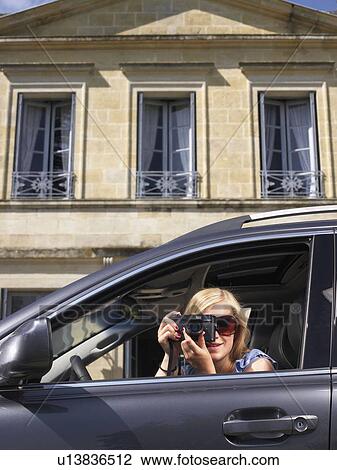 Stock Image - Woman taking a picture. Fotosearch