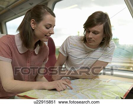 Stock Image - Young couple on train. Fotosearch