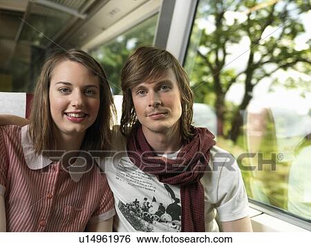 Young couple on train View Large Photo Image Stock Photograph - Young couple on train. Fotosearch