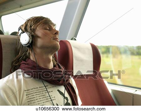 Stock Image - Young man on train. Fotosearch