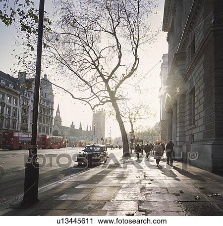 Stock Image - Background people walking through the streets of London.. Fotosearch