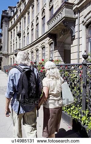 Stock Image - Couple walking away from camera. Fotosearch