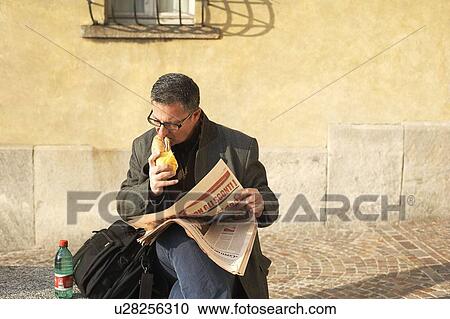 Stock Image - Man eating sandwich. Fotosearch
