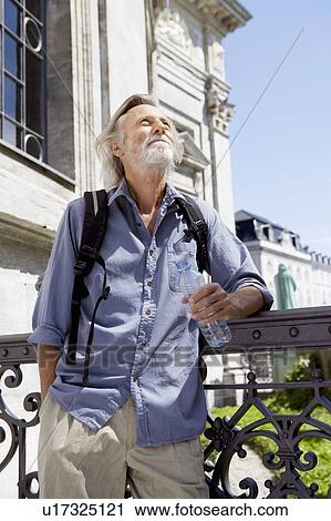 Stock Image - Man in front of historic monument. Fotosearch