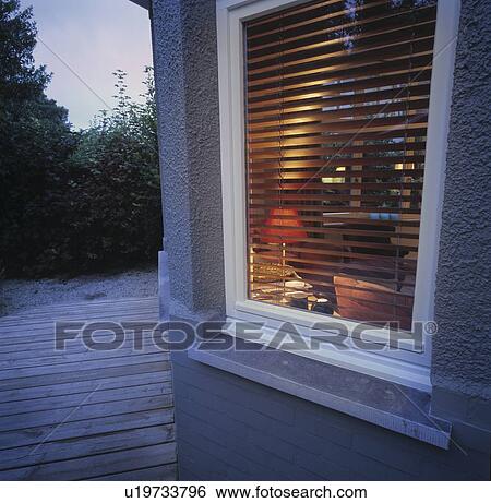 Stock Photograph - Outside a house with a deck.. Fotosearch
