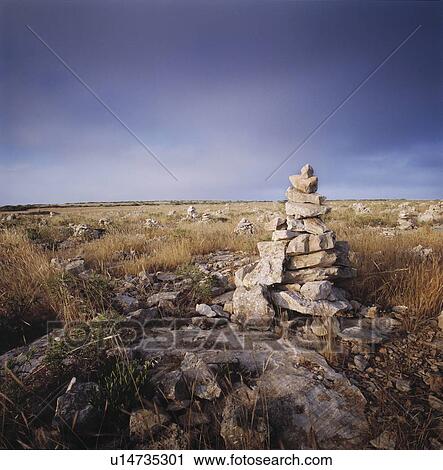 Small pyramid of rocks in a grass field. View Large Photo Image Stock Image - Small pyramid of rocks in a grass field.. Fotosearch