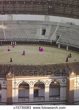 Stock Image - Spain, Andalusia, Malaga, matadors training in bullring, elevated view. Fotosearch