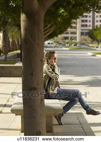 Stock Image - Teenage female on mobile phone. Fotosearch