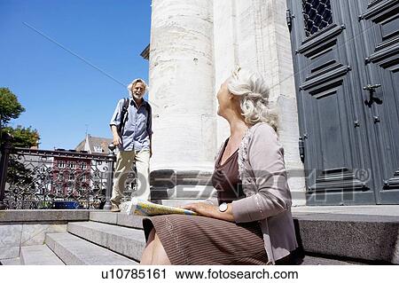 Stock Image - Woman looking over at man. Fotosearch