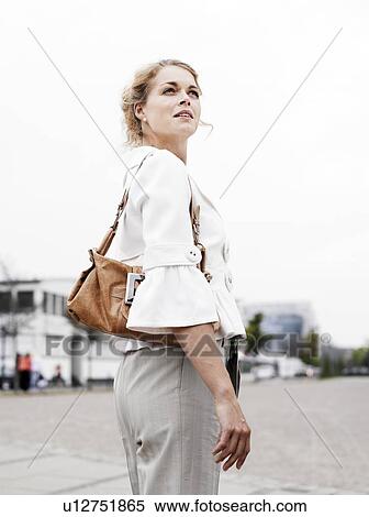Woman standing outdoors View Large Photo Image Stock Photography - Woman standing outdoors . Fotosearch