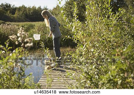 Young Woman by pond with fishing net. View Large Photo Image Stock Photo - Young Woman by pond with fishing net.. Fotosearch