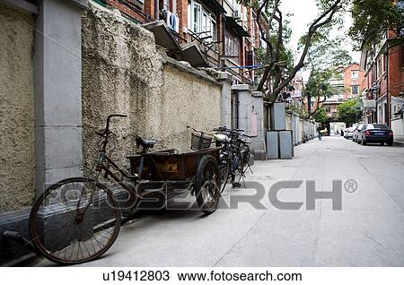 China, Shanghai, a street between old apartment buildings View Large Photo Image Stock Image - China, Shanghai, a street between old apartment buildings. Fotosearch