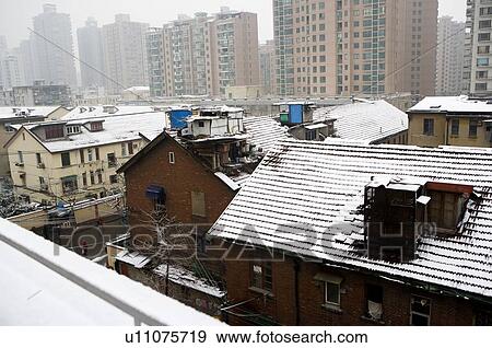 Stock Photo - China, Shanghai, buildings covered with snow, elevated view. Fotosearch