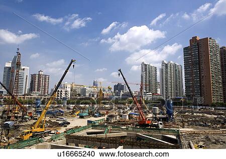 Stock Image - China, Shanghai, construction site amongst buildings. Fotosearch