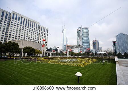 Stock Image - China, Shanghai, lawn at Government Building Square. Fotosearch