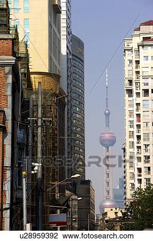 Stock Image - China, Shanghai, Oriental Pearl Tower and dwelling buildings. Fotosearch