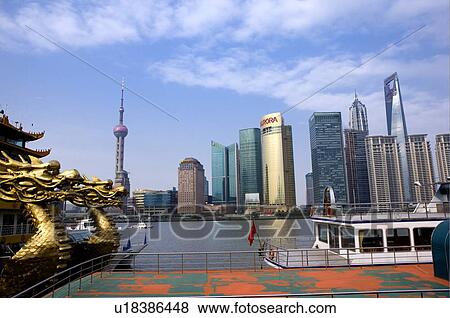 Stock Photo - China, Shanghai, Pudong, Huangpu River, View of Oriental Pearl tower and skyline from boat. Fotosearch