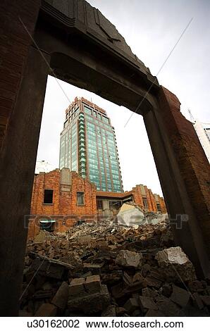 Stock Image - The contrast of ruins and skyscraper. Fotosearch