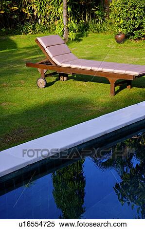Chaise longue on the lawn View Large Photo Image Stock Photography - Chaise longue on the lawn. Fotosearch