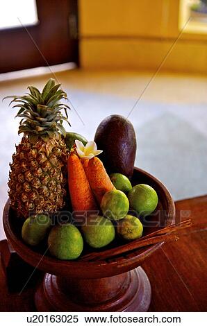 Stock Photography - Pineapple, carrot, and oranges on the plate. Fotosearch