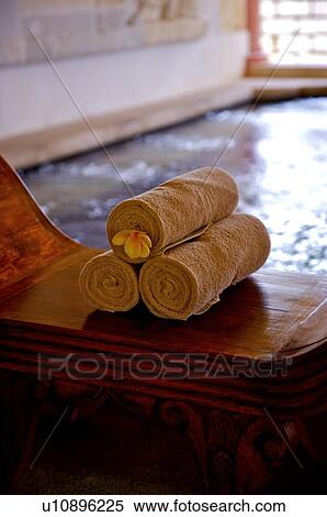 Rolled towel with frangipani on desk View Large Photo Image Stock Photography - Rolled towel with frangipani on desk. Fotosearch