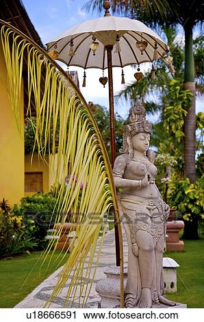 Sculpture of a women under sunshade in Bali, Indonesia View Large Photo Image Stock Image - Sculpture of a women under sunshade in Bali, Indonesia. Fotosearch