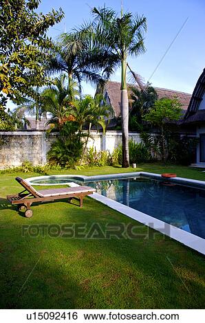 Stock Photograph - Swimming pool in front of outdoor chair. Fotosearch