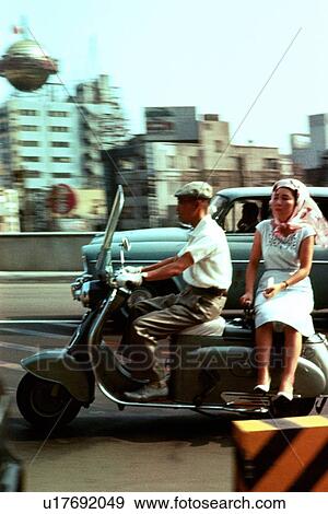 Man and woman on Scooter View Large Photo Image Stock Photo - Man and woman on Scooter. Fotosearch