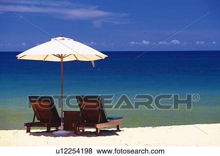 Stock Photo - Beach Umbrella and Deckchair, Rear View. Fotosearch