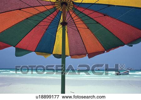 Stock Photo - Colorful Beach Umbrella, Low Angle View. Fotosearch