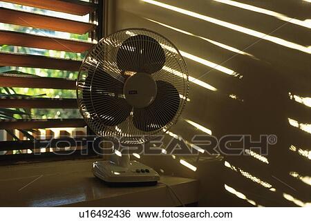 Stock Photograph - Electric Fan by the Window, Side View. Fotosearch
