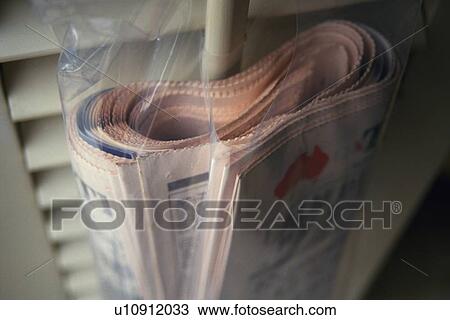 Stock Image - Newspaper in Plastic Bag, High Angle View, Close Up, Differential Focus. Fotosearch