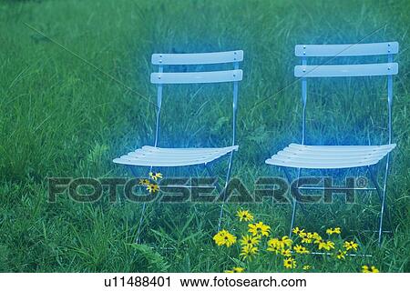 Stock Image - Two Chairs on Grass, Side View, Soft Focus. Fotosearch